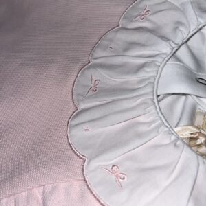 Pink baby dress with embroidered collar details.