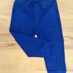 Blue toddler pants on wooden surface.