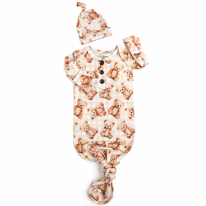 Baby outfit with teddy bear pattern and matching hat.