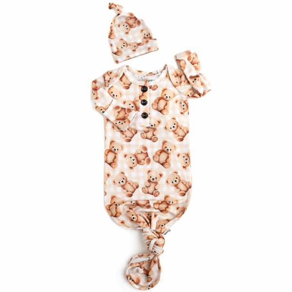 Baby outfit with teddy bear pattern and matching hat.