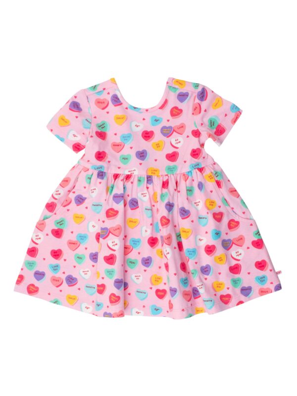 Pink dress with colorful heart patterns.