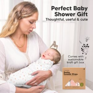 Mother cuddling baby with swaddle wrap gift box.