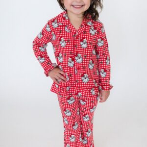 Child in red Santa pajamas smiling