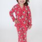 Child in red Santa pajamas smiling