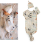 Baby wearing animal print onesie and matching hat
