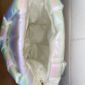 Open iridescent puffer bag on side view
