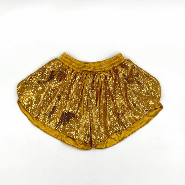 Golden sequin shorts on white background.