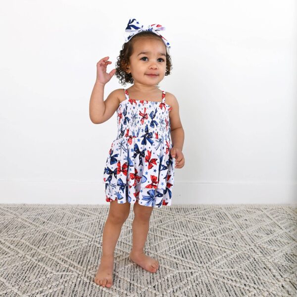 gigi and max eleanor bow clip bow 4th of july hair accessory Toddler in butterfly print dress and matching headband.