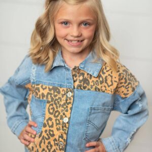 Girl wearing denim leopard print jacket smiling