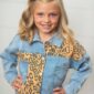 Girl wearing denim leopard print jacket smiling