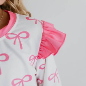 Pink bow-patterned dress with ruffle sleeve detail.