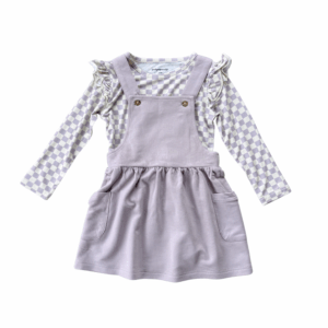 Purple pinafore dress with checkered long sleeve shirt