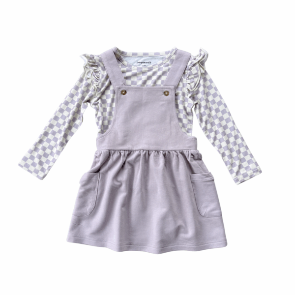 Purple pinafore dress with checkered long sleeve shirt