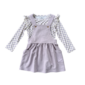 Purple pinafore dress with checkered long sleeve shirt