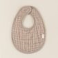 Beige textured baby bib with snaps.