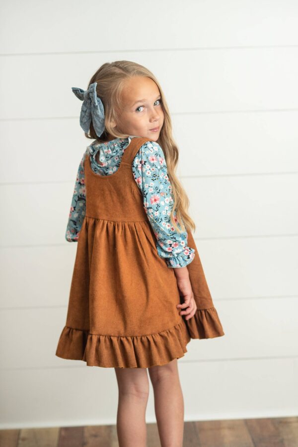 wren & james kids blue floral smocked top & caramel corduroy jumper set Girl wearing brown dress with blue floral shirt