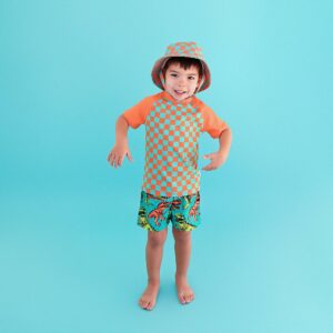 Child in colorful swimwear on blue background