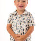 Child wearing duck pattern polo shirt smiling