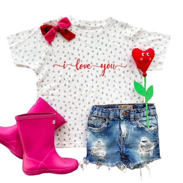 Polka dot shirt, boots, denim shorts, and heart flower.