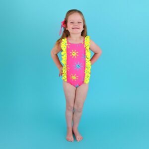 Child wearing colorful swimsuit with sun design