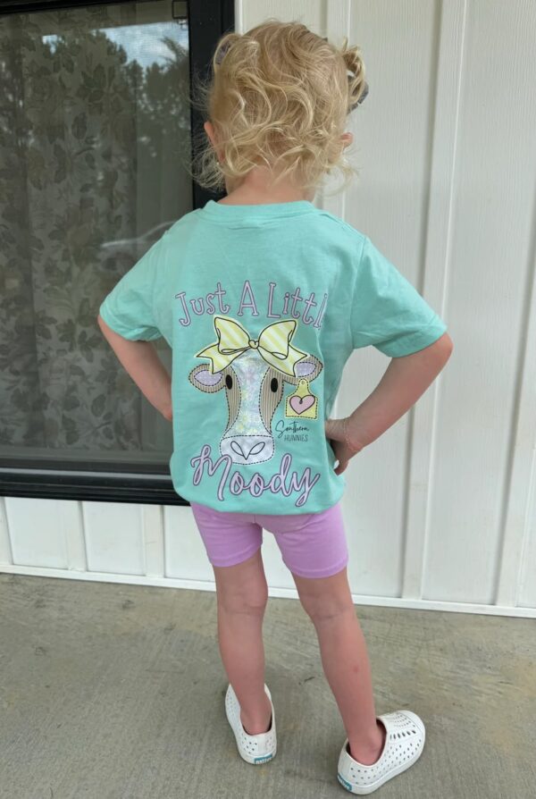 Child wearing Moody cow shirt with bows