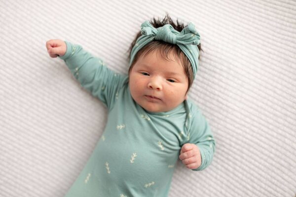three little tots arrow print knotted newborn baby gown pajamas Baby in green onesie with matching headband