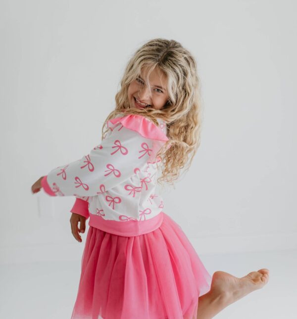 product Smiling girl in pink tutu and bow sweater