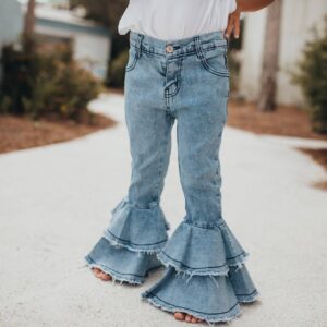 Child wearing flared denim jeans on path