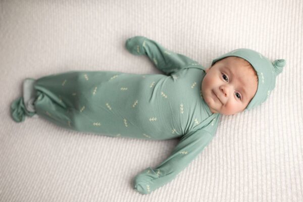 three little tots arrow print knotted newborn baby gown pajamas Baby in green outfit lying on blanket