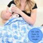 Mom feeding baby under blue floral muslin blanket.