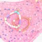 Colorful beaded bracelets on pink sequin background.