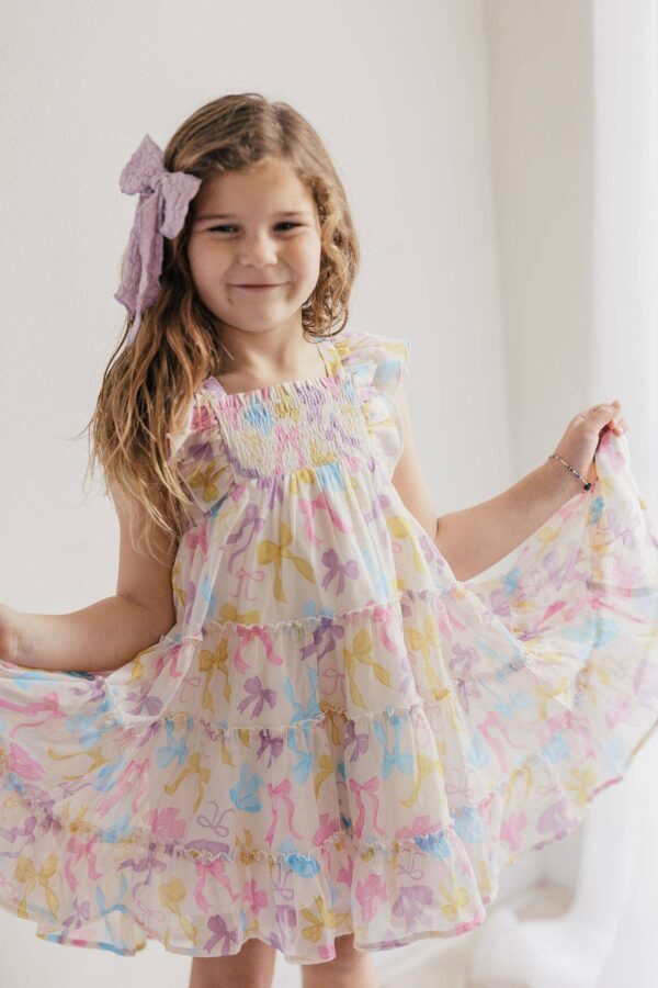 Smiling girl in colorful dress with bow headband