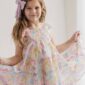 Smiling girl in colorful dress with bow headband