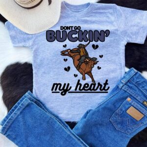 Cowboy-themed shirt and jeans with bull graphic.