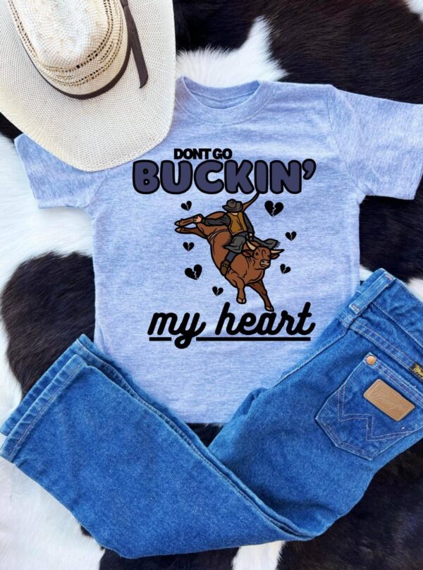 Cowboy-themed shirt and jeans with bull graphic.