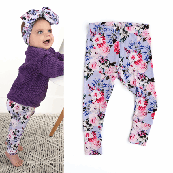 Baby in floral outfit with headband.
