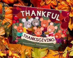Thankful Thanksgiving book with fall leaves background.