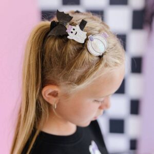 Girl wearing Halloween-themed hair accessories.