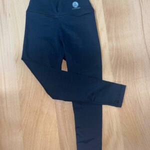 Black leggings on wooden floor.