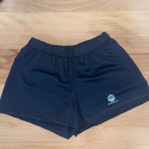 Black yoga shorts on wooden surface.