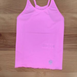 Pink tank top on wooden surface.