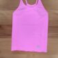 Pink tank top on wooden surface.