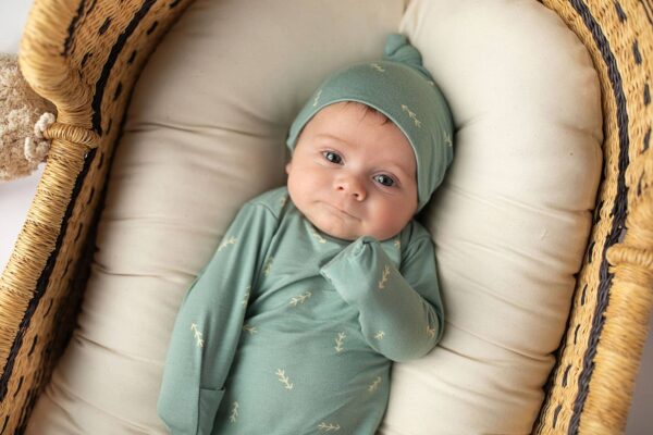 three little tots arrow print knotted newborn baby gown pajamas Baby in green outfit lying in basket