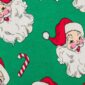Santa faces and candy canes on green background