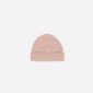 Pink knitted beanie hat on white background.