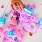Child playing with princess doll and colorful playdough.