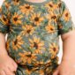Baby wearing floral sunflower patterned outfit