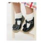Child's black shoes with bows and socks.