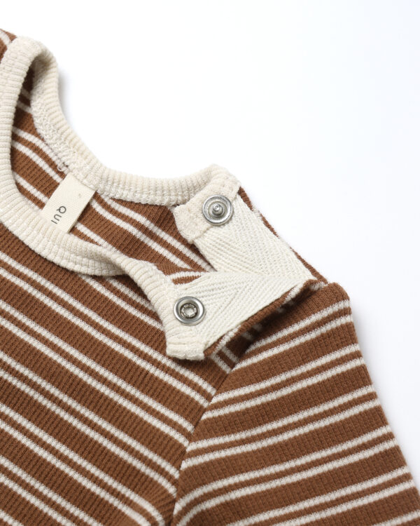 Brown and white striped baby sweater with buttons.