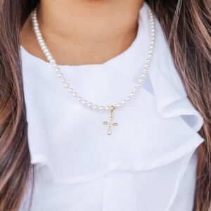 Pearl necklace with gold cross pendant.
